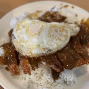 a plate of food with rice and meat