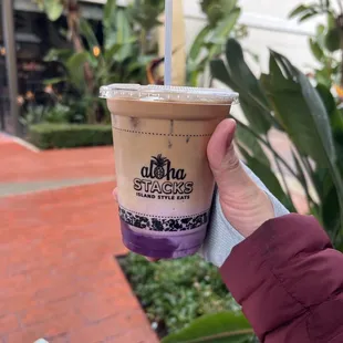 a hand holding a cup of coffee