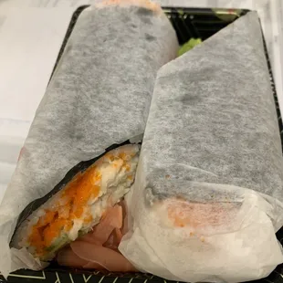 two pieces of sushi wrapped in paper