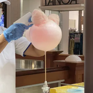 a man holding a cotton candy