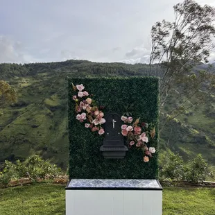 Customize the green wall with florals to match your event!