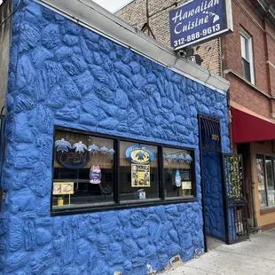 a blue building on a city street