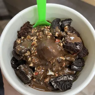 a person holding a cup of ice cream