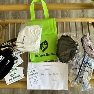 KN95 masks, white and black, goggles, fabric masks, and tote bag.