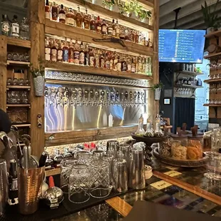 a bar with shelves of bottles and glasses