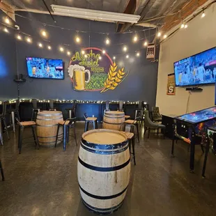 a game room with beer and pinball machines