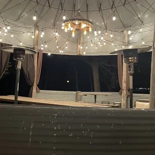 Winter Solstice moon in the outdoor gazebo window.