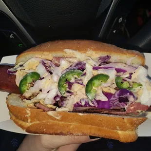 a hot dog with coleslaw and jalapenos