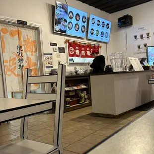 a restaurant with a counter and chairs