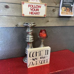 a red table with a sign that says, follow your heart