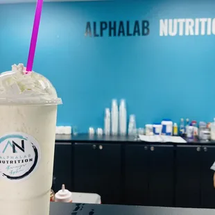 a milkshake with a purple straw