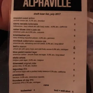 a hand holding a menu for a restaurant