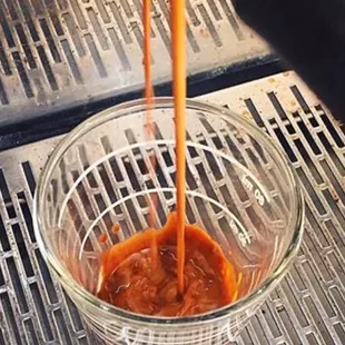 a person pouring coffee into a bowl