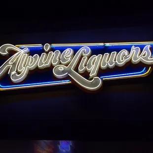 a neon sign for alpine liquor