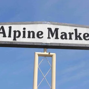 the sign for alpine market