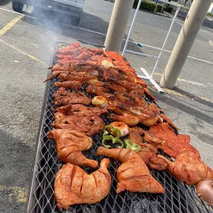 a grill full of meat and vegetables