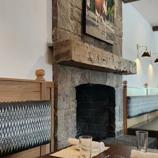 a dining room with a fireplace in the background