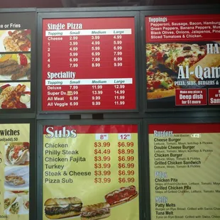 menus and prices on a brick wall