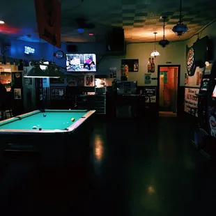a pool table and arcade machines