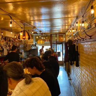 people sitting at tables in a restaurant