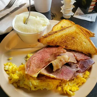 Country ham with grits, buttered toast and scrambled eggs with cheese.