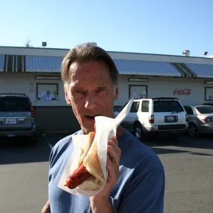 a man eating a hot dog