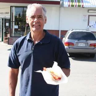 a man holding a hot dog