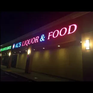 a neon sign for a liquor and food store