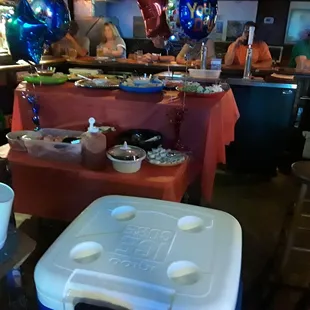 a table of food and balloons
