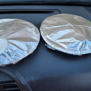 two tinfoils on the dashboard of a car