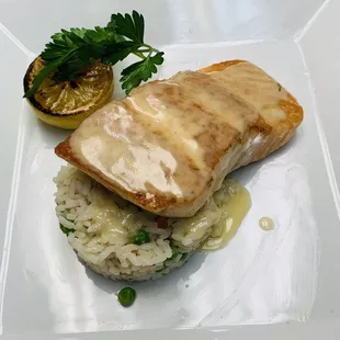 Atlantic Salmon over white rice and beurre blanc sauce.