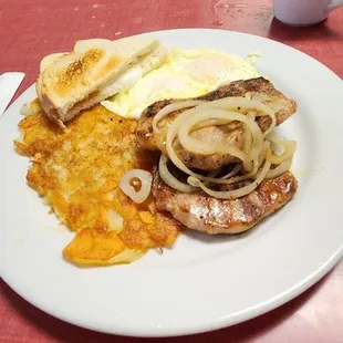 Breakfast: porkchops  with over easy eggs  and hash browns made with scalloped potatoes    delicious