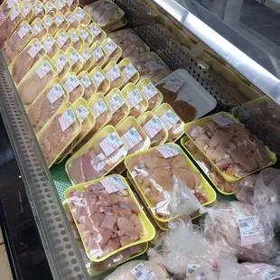 a display of meat in plastic containers