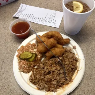 Large chopped barbecue pork plate with hushpuppies, slaw, and sweet tea.
