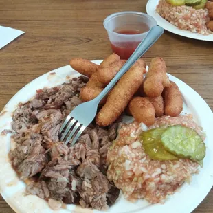 Pork coarse chopped brown with hushpuppies and extra sauce