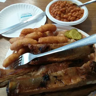 Rib plate with slaw, hush puppies and beans. Shelby bbq at its best