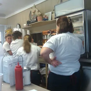 Waitresses at the Food Pickup window near the counter.