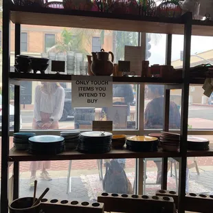 a shelf with pots and pans on it