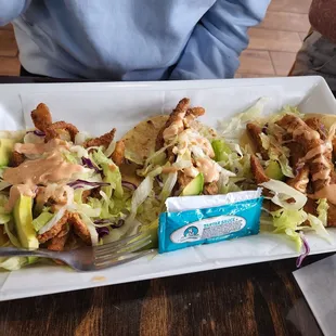 a plate of tacos and a fork
