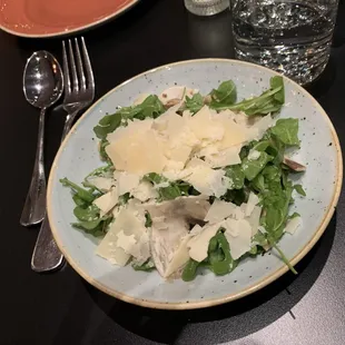 a plate of salad and a glass of water