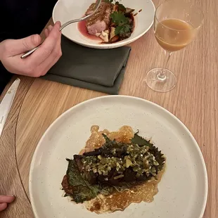 a plate of food and a glass of wine