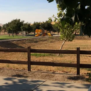View of one of three jungle gyms. This jungle gym had enclosed swings for toddlers as well as normal swings for older kids.