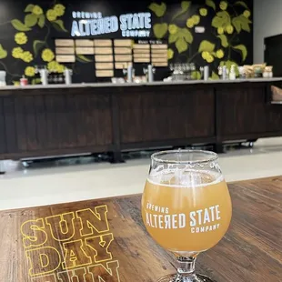 a glass of beer on a wooden table