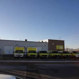 a row of trucks parked in front of a building