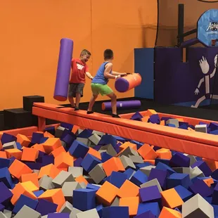 Playing on the Battle Beam at Altitude Trampoline Park at Cityview