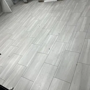 Bathroom with bugs and dirty toilet paper on the floor.