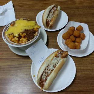 three plates of chili cheese hot dogs