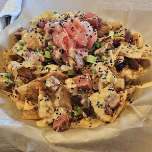 Tuna Nachos Grilled tuna, wonton chips, bang bang sauce, spicy teriyaki, pickled ginger, green onions, sesame seeds $16