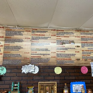 a menu on a brick wall