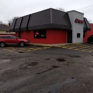 a red truck parked in front of the restaurant